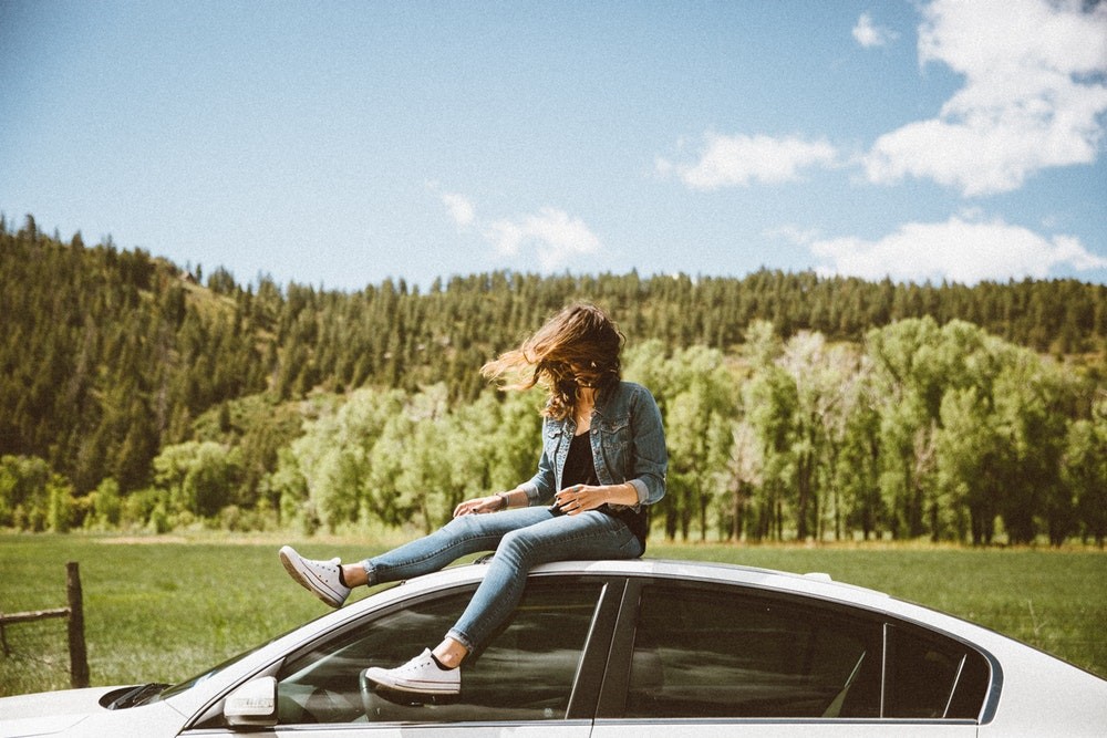 person sitting on car | Buddii